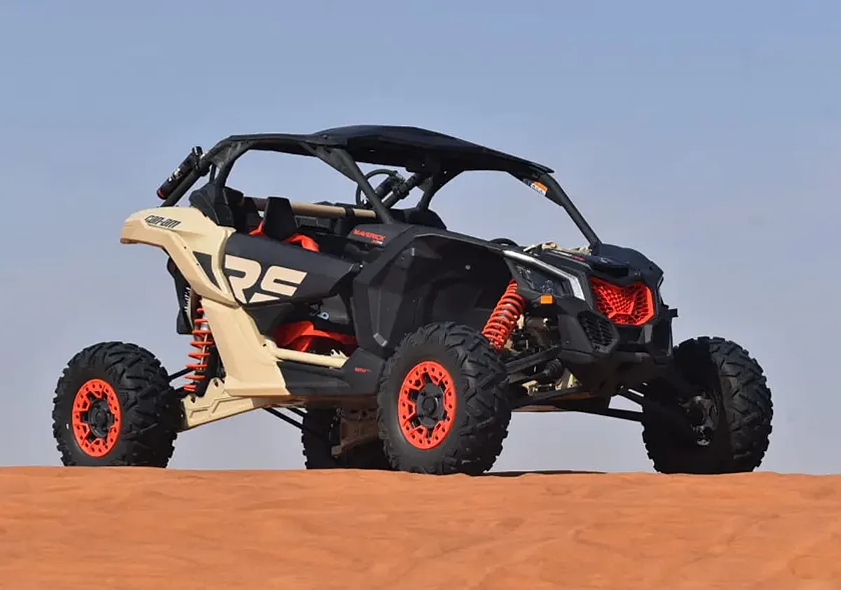 2 Seater Can-Am Maverick dune buggy on red sand